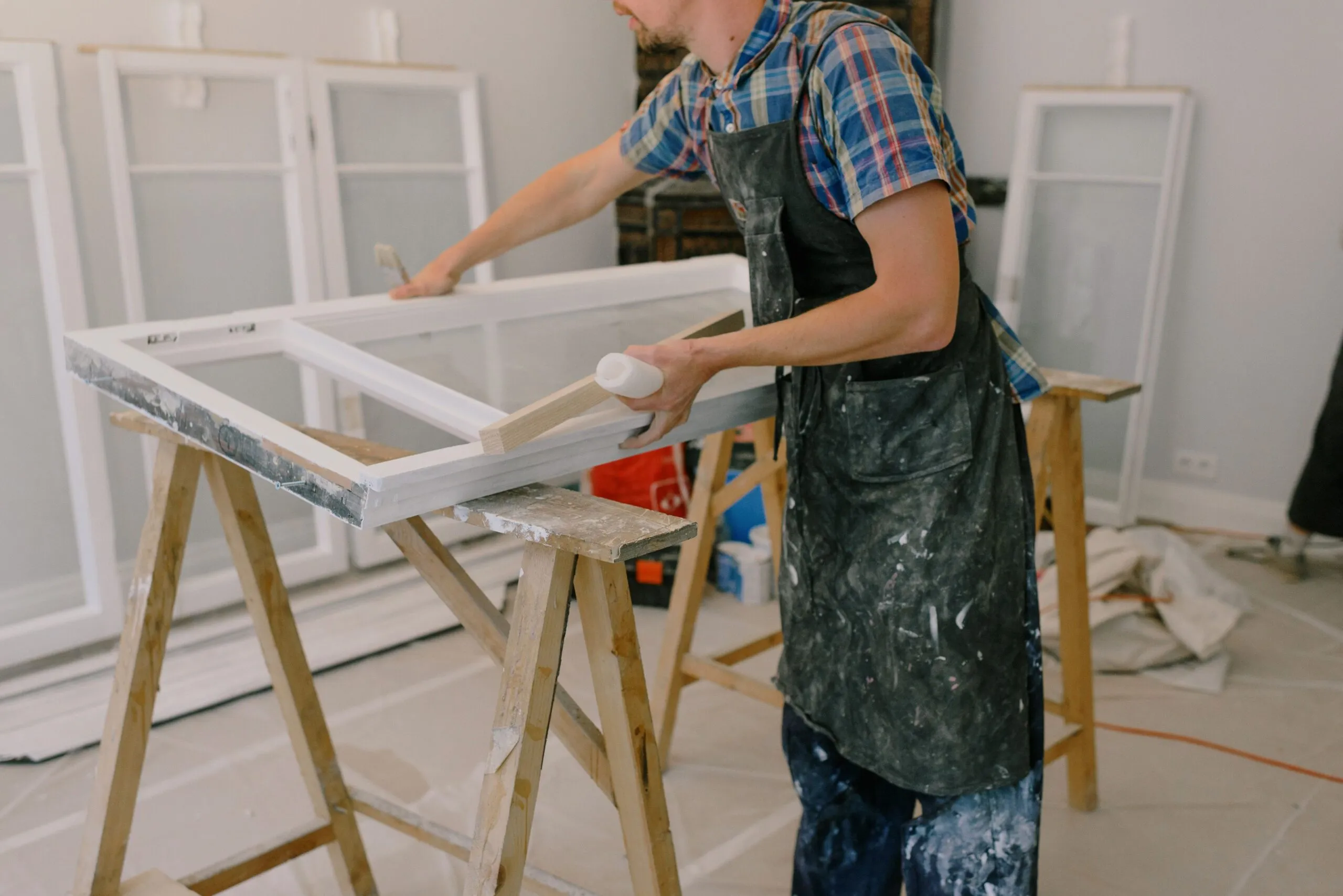 Home Exchange handyman repairing a window frame indoors